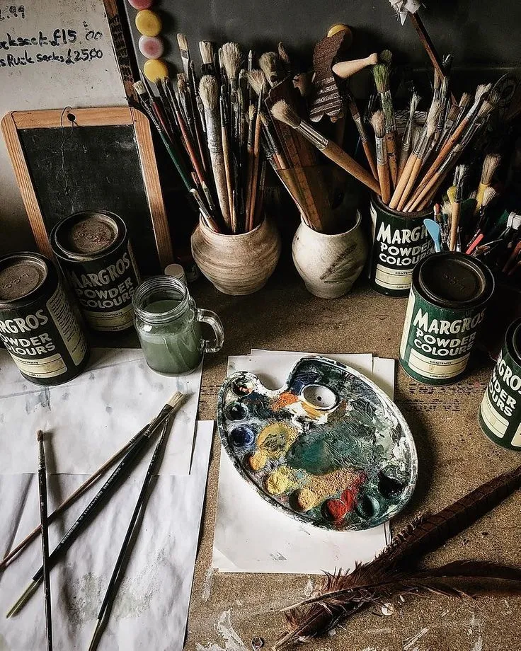 An artist’s workbench with brushes, pigments and a well-used palette